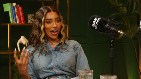 Model and activist Munroe Bergdorf sits by a microphone for a BBC Sounds interview