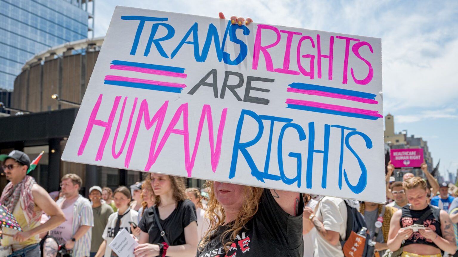 Protester holds up a sign that reads