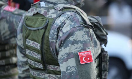 The side of a person in Turkish military fatigues.