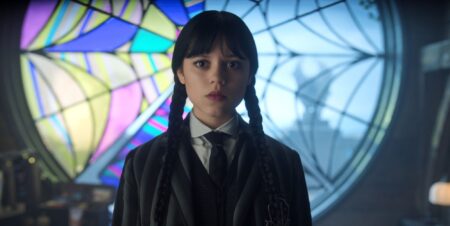 Jenna Ortega looks solemn and a little shocked in a still from Wednesday season two.