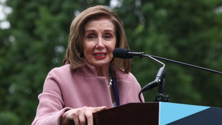 Representative Nancy Pelosi speaks at a podium