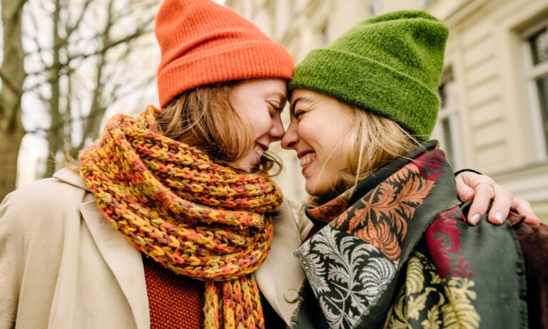 Two women lovingly embracing.
