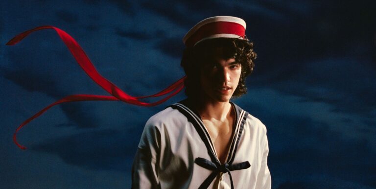 An image of Conan Gray in a white sailor suit for his album Wishbone