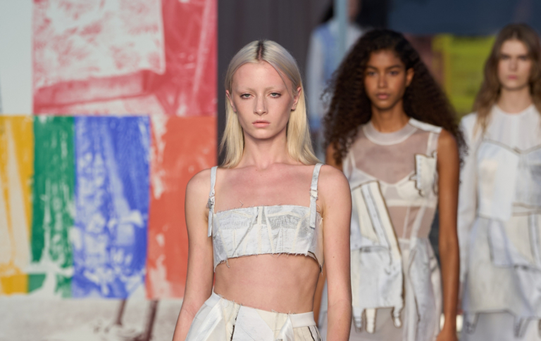 Kai Schreiber opens Jason Wu's New York Fashion Runway show. She's wearing a white fabric bralette and skirt