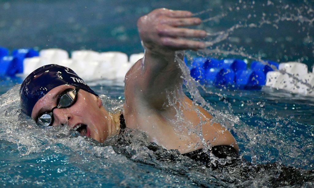 Une femme dans une piscine exécutant une brasse avant.