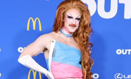 Pattie Gonia in her trans flag dress.