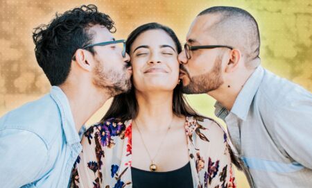 Two people kissing one person.