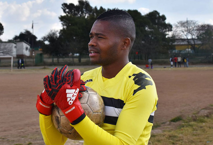 Le footballeur gay sud-africain Phuti Lekoloane tient un ballon de football