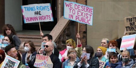 Trans rights demonstrators gather outside the Equalities and Human Rights Commission