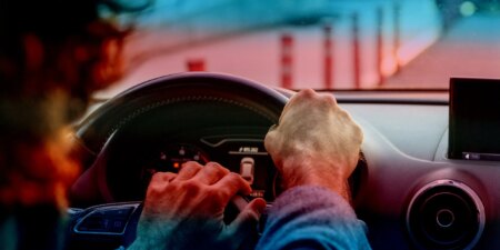 stock image of person driving with trans pride colours