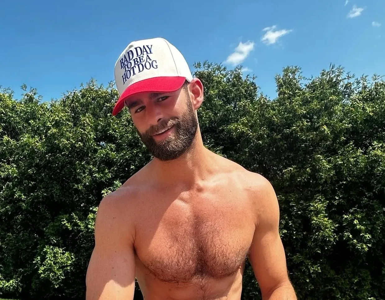 Chris Salvatore dans un jardin portant un chapeau
